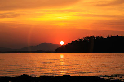 Scenic view of sea against romantic sky at sunset