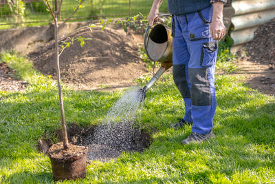 Low section of man working on field
