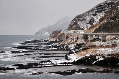 Sea by mountains in foggy weather during winter