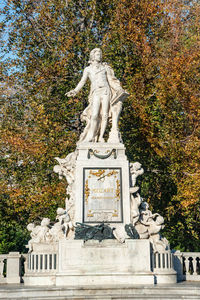 Statue of angel during autumn