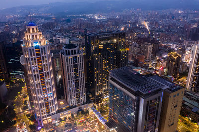 High angle view of illuminated buildings in city at night