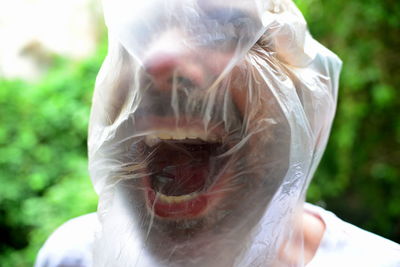 Close-up of man wearing plastic