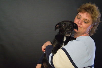 Portrait of woman holding puppy