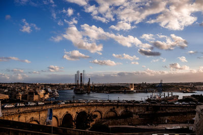 View of bridge over river against cloudy sky