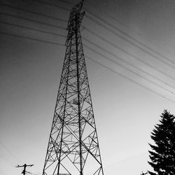 Low angle view of communications tower against sky