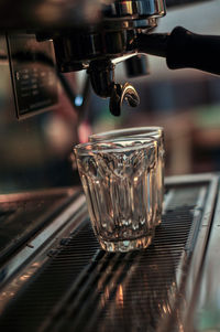 Close-up of coffee cup in glass