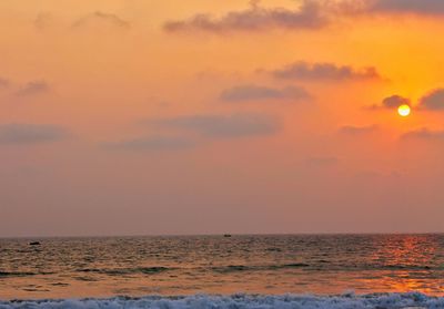 Scenic view of sea against orange sky