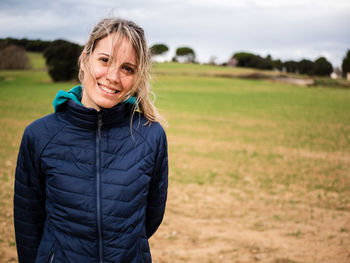 Portrait of smiling woman standing on land