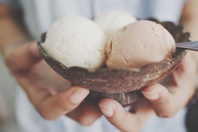 Midsection of woman holding ice cream