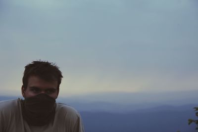 Man looking away against sky