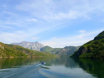 Scenic view of lake and mountains against sky