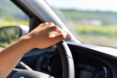 Midsection of man driving car