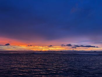 Scenic view of sea against romantic sky at sunset