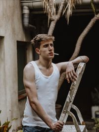 Portrait of young man sitting outdoors