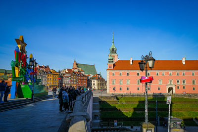 Low angle view of buildings against clear blue sky