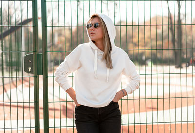 Young woman wearing sunglasses standing outdoors