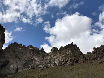 Low angle view of rocks on land against sky