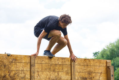 Low angle view of man looking away against sky