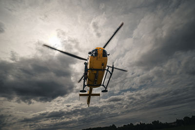 Low angle view of helicopter against sky
