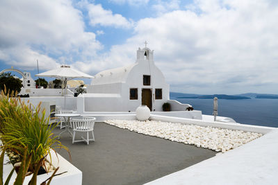 View of swimming pool by building against sky