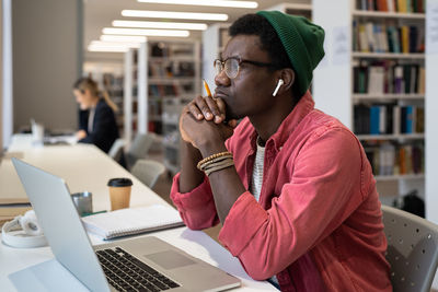 Young man using laptop at table