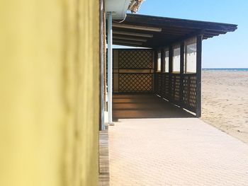 Corridor of building by sea against sky, bar on the beach 