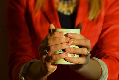 Close-up of hand holding tea cup