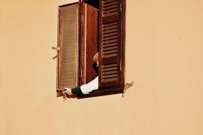 Man sitting on floor against wall