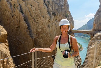 Portrait of woman standing on rock