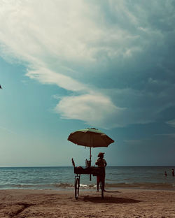 People on beach against sky