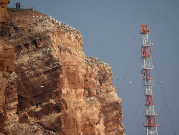 Low angle view of communications tower against sky