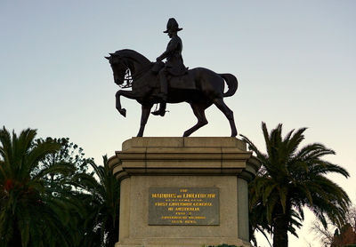 Low angle view of statue against sky