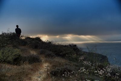 Scenic view of landscape against cloudy sky