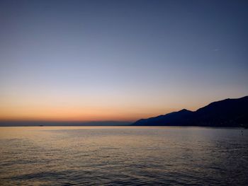 Scenic view of sea against clear sky during sunset