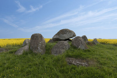 Hay bales on field against sky
