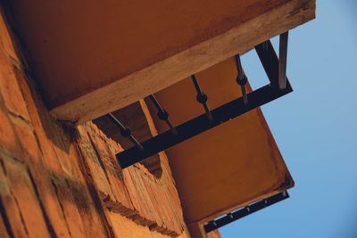 Low angle view of electric lamp against clear sky