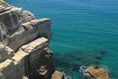 High angle view of rocks by sea