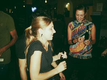 Young woman standing by food at night