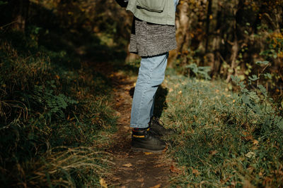 Low section of person standing on field