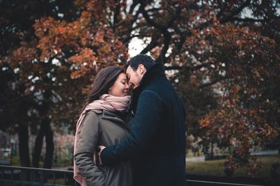 Side view of couple kissing in park