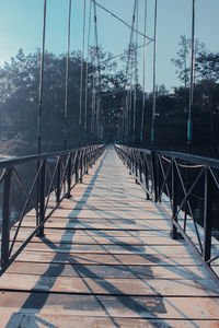 Empty footbridge against sky