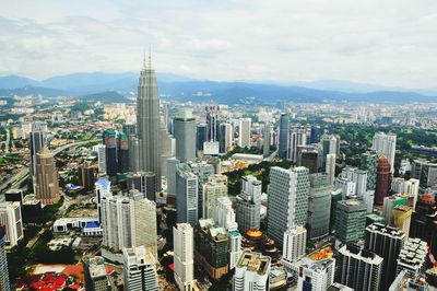 Petronas tower in city against sky