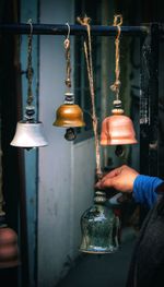 Close-up of hand holding bell against the wall, dastakaar 