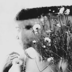 Double exposure of woman and flowers against white background