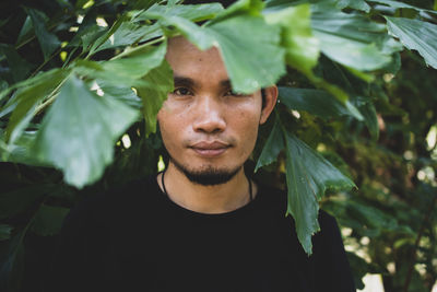 Portrait of young man with leaves