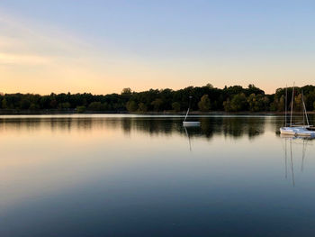 Scenic view of lake against sky at sunset