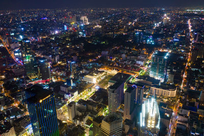 High angle view of city lit up at night