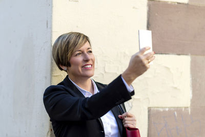 Portrait of businessman using mobile phone