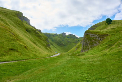 Scenic view of green mountains against sky