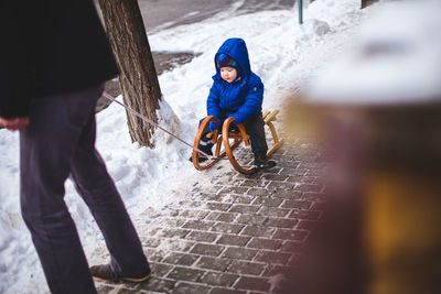 Boy with umbrella on snow